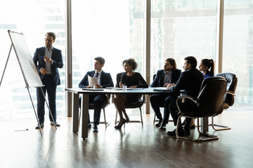 Confident businessman flip charts presentation new project in boardroom.