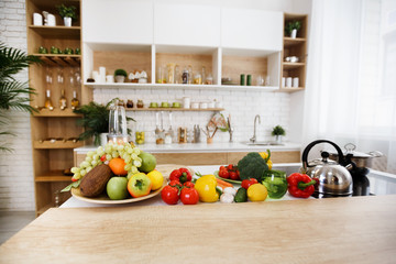 Obraz na płótnie Canvas Kitchen interior. Fresh fruits and vegetables on table
