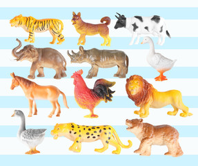 Group of plastic animal doll isolated on color background
