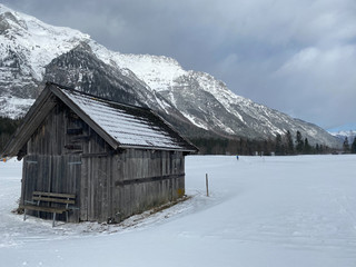 Winter mountains landscape with wooden barn Leutasch, Austria.