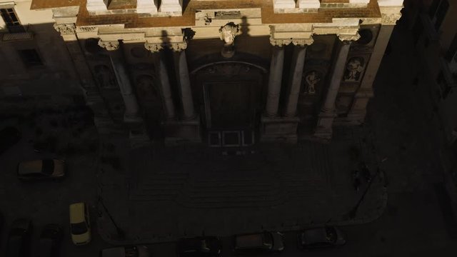 Cinematic flying on an early sunny morning over an old Baroque Church in the historic part of Palermo. Aerial shoot