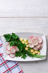 Fototapeta na wymiar Vegetable salad with radish, mini corn, cucumber and herbs. Diet healthy meal, fitness