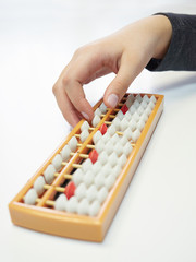 Classes in mental arithmetic, hands and abacus soroban on white background. closeup