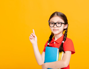 Adorable student girl holding the books and showing something