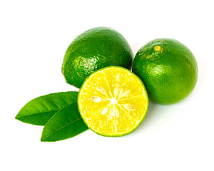 Two homegrown raw Asian limes with half cut slices and green leaves isolated on white