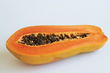 A half cut delicious papaya on white background