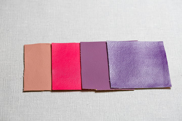 square pieces of multi-colored fabric laid out on a gray background