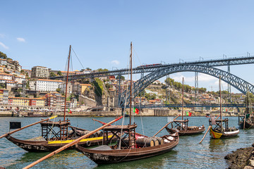 Fototapeta na wymiar Old traditional boats with wine barrels in Porto, Portugal
