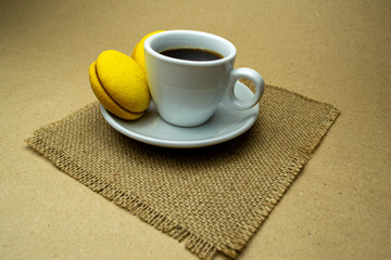 Cup of coffee with macaroons on a napkin