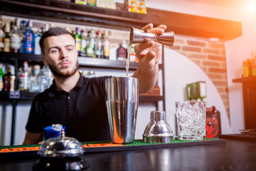 Bartender is making non alcoholic cocktail at bar counter.