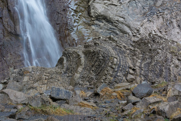 Waterfall falling on a rocky wall, texture