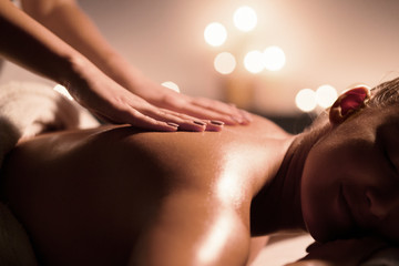 Woman getting massaging treatment in luxury spa