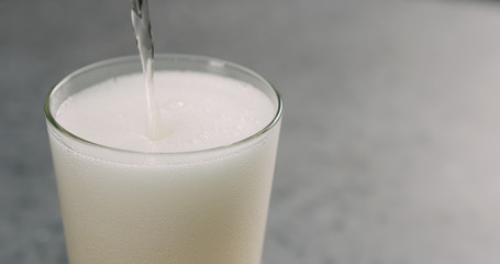 pour apple cider into pint glass closeup