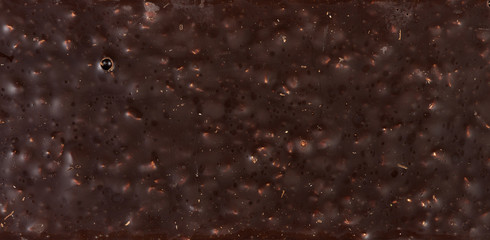 Top view texture of back of chocolate bar with almond nut