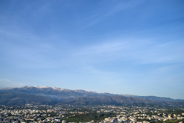 Panoramic aerial view from above of the city of Chania, Crete island, Greece with white mountains, beautiful venetian town Chania in Crete island. Chania, Crete, Greece.