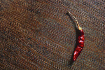 Bunch of dried red chilli peppers on a wooden board