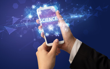 Female hand holding smartphone with SCIENCE inscription, modern technology concept