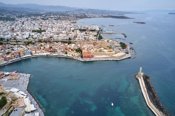 Fototapeta premium Panoramic drone aerial view from above of the city of Chania, Crete island, Greece. Landmarks of Greece, beautiful venetian town Chania in Crete island. Chania, Crete, Greece.