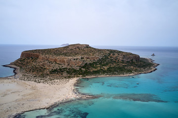 Amazing aerial drone top panoramic view on the famous Balos beach in Balos lagoon and pirate island Gramvousa. Place of the confluence of three seas. Balos beach, Chania. Crete island. Greece. Europe.
