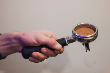 Holder with coffee in male hands.