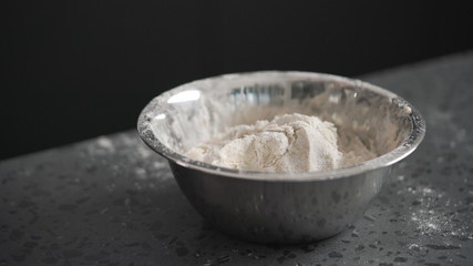 dough in steel bowl on concrete countertop