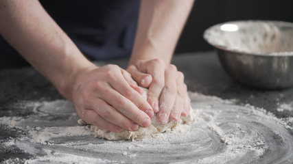 Obraz na płótnie Canvas man working with dough on concrete countertop