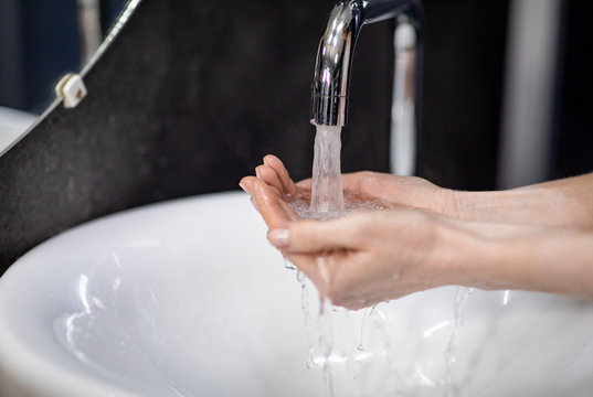 Unrecognizable Mature Woman Washing Hands In Bathroom, Selective Focus