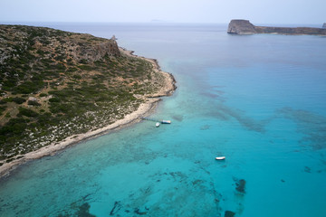 Amazing aerial drone top panoramic view on the famous Balos beach in Balos lagoon and pirate island Gramvousa. Place of the confluence of three seas. Balos beach, Chania. Crete island. Greece. Europe.