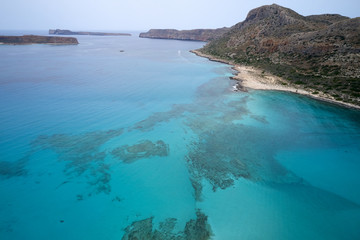 Amazing aerial drone top panoramic view on the famous Balos beach in Balos lagoon and pirate island Gramvousa. Place of the confluence of three seas. Balos beach, Chania. Crete island. Greece. Europe.