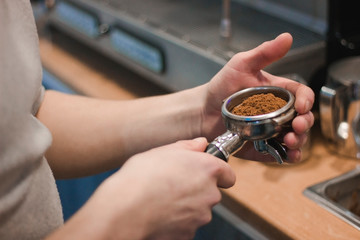 Holder with coffee in male hands.