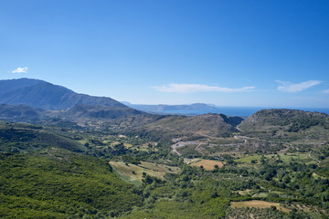 Unique panoramic aerial view of rural region landscape. Green meadows, olive tree groves, and vineyards, in spring Crete, Greece.