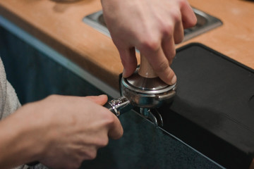 The process of making coffee. Barista and coffee machine