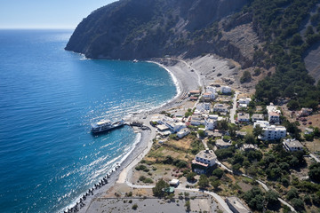 Fototapeta premium Aerial drone view of Agia Roumeli beach in Chania of Crete, Greece. The village of Agia Roumeli is located at the entrance of the gorge Samaria