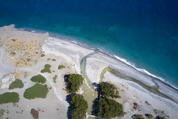 Aerial drone view of Agia Roumeli beach in Chania of Crete, Greece. The village of Agia Roumeli is...