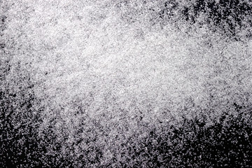 Abstract wallpaper design of white color shiny snow dust powder isolated on black background