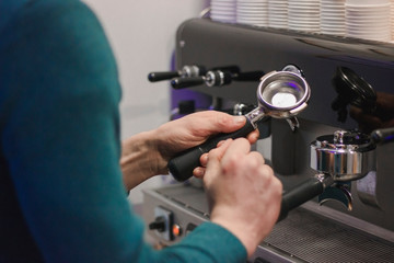 The process of making coffee. Barista and coffee machine