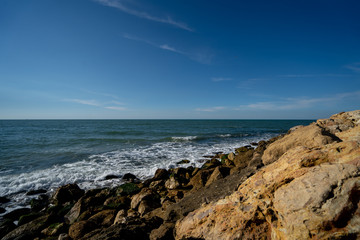 Fototapeta na wymiar Rocky sea coast. Sunny day