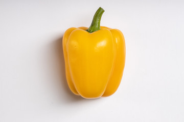 Bright yellow sweet bell peppers are yummy, versatile and nutritious. Fresh vegetables are used for making salad, side dish. delicious vegetable isolated on white background