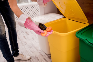 Young girl sorting garbage at the kitchen. Concept of recycling. Zero waste