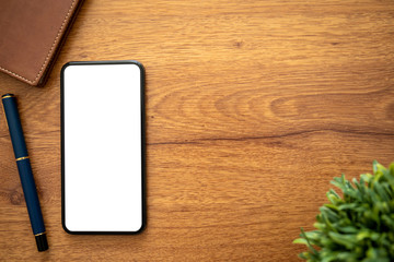 phone with isolated screen on desk with pen and notebook