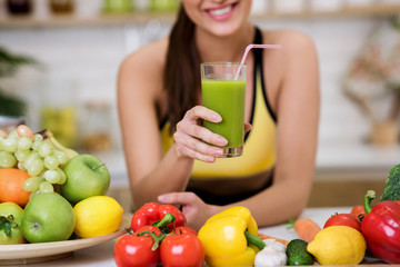 Raw food diet. Sports girl holding glass of smoothie
