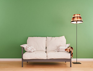 Olive green mock-up wall with small white sofa and floor lamp in modern interior background,...