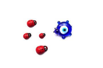 ladybug and evil eye bead on a white background, close up ladybug, evil eye bead and luck