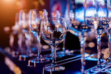 Wine and martini glasses in shelf above a bar rack in restaurant. 
