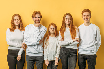 beautiful red haired brothers and sisters posing together. young people with natural red hair...