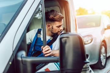Handsome middle age man working in towing service on the road. Roadside assistance concept.