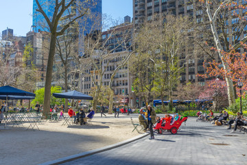 People enjoy the weather on a spring day at Bryant Park in New York City,USA