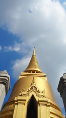 Thailand Beautiful Golden Pagoda with blue sky background at Wat Pra Kaew (Temple of the Emerald Buddha).