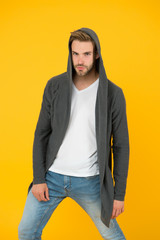 Casual menswear. Freedom of movement. Fashion trends. Modern clothes for youth. Sporty style. Fashion man yellow background. Fashion look. Handsome guy wear fashionable mantle with hood
