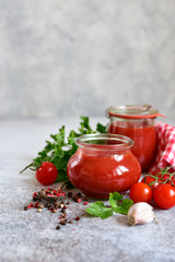 Obraz na płótnie Canvas Homemade spicy tomato ketchup in a vintage jars.